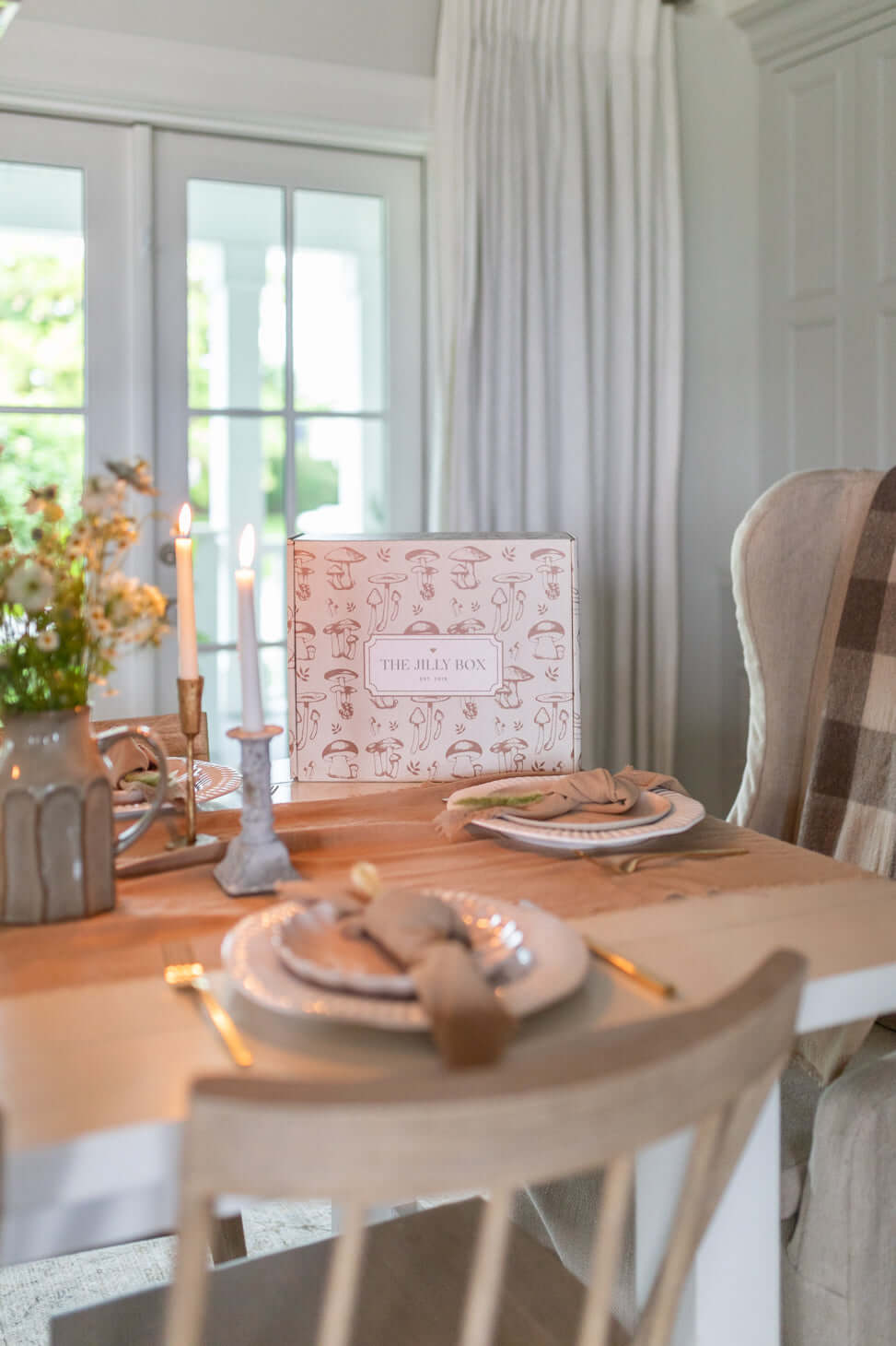 Jilly box home feature of white beachwood table with our linen napkins and table runner set in a farmhouse setting