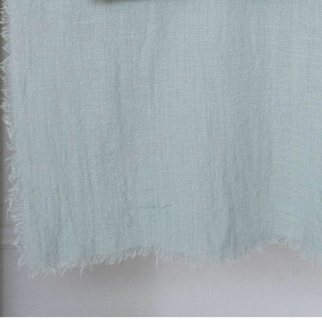 close up of maison table runner in light blue grey colour