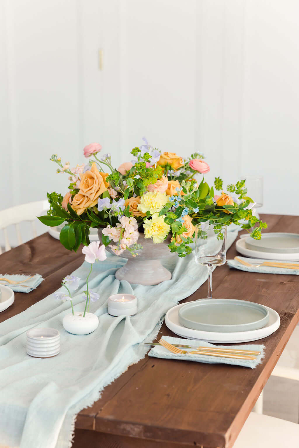 tablescape with big floral arrangement and maison collection items