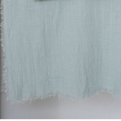close up of maison table runner in light blue grey colour