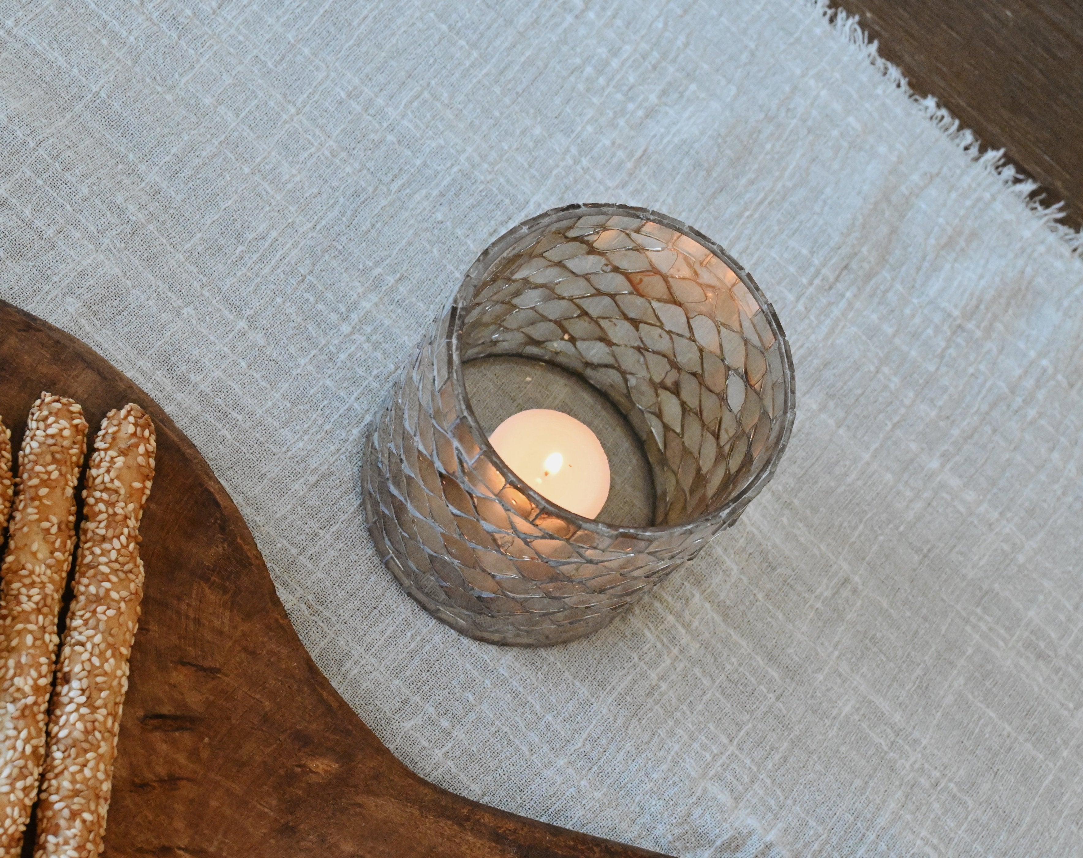 top view of two glass votive candle holders sitting on a white table