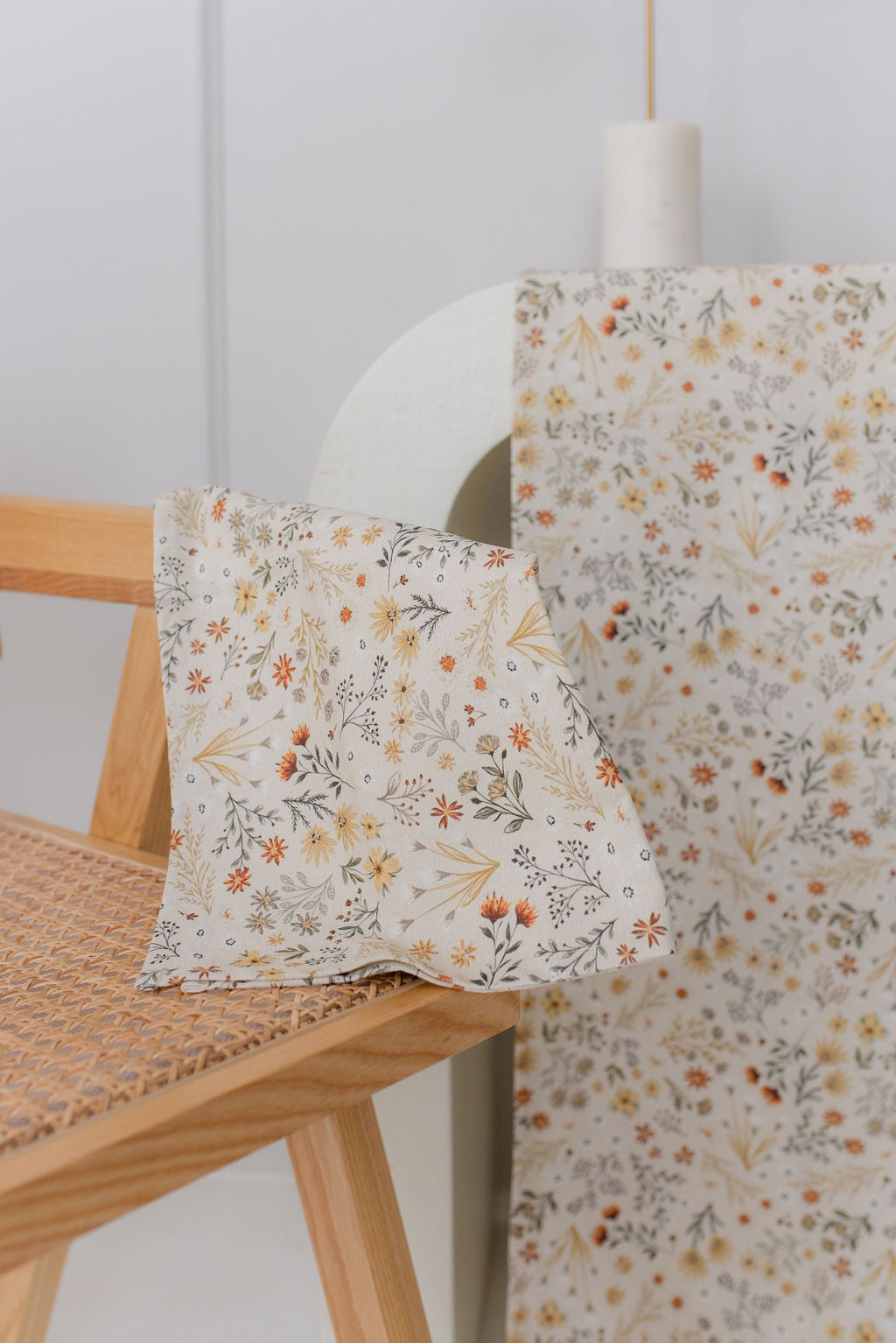 fall meadow napkin drapped over light cane chair