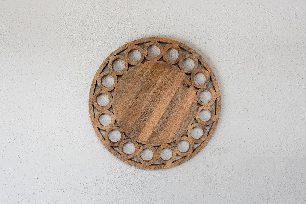 wooden circle charger centered on white texured surface